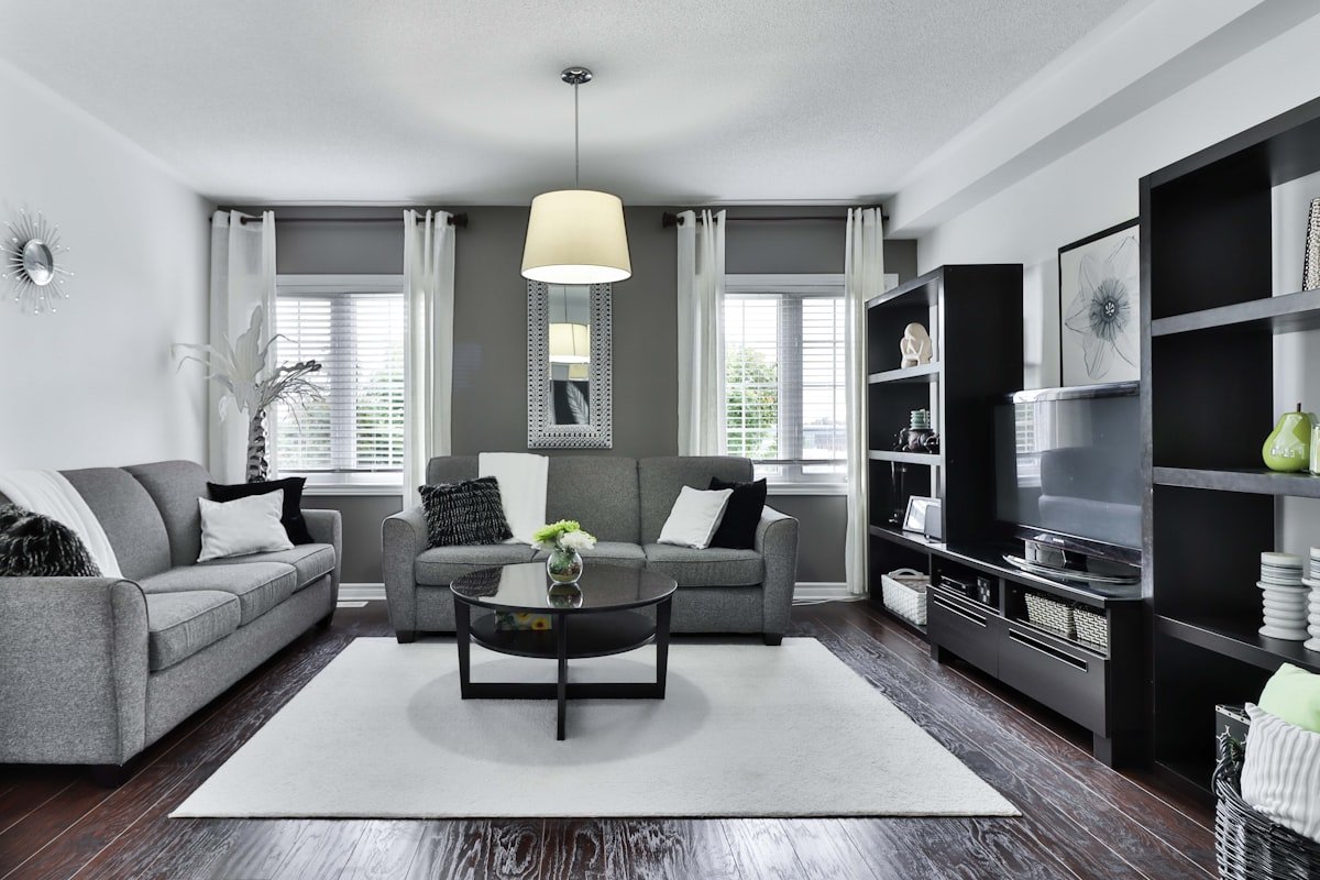 Living room with large textured wool area rug grounding sofa and coffee table
