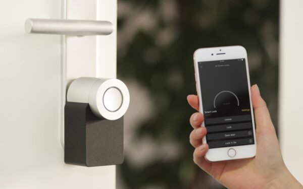 Smart home digital thermostat interface mounted on clean interior wall
