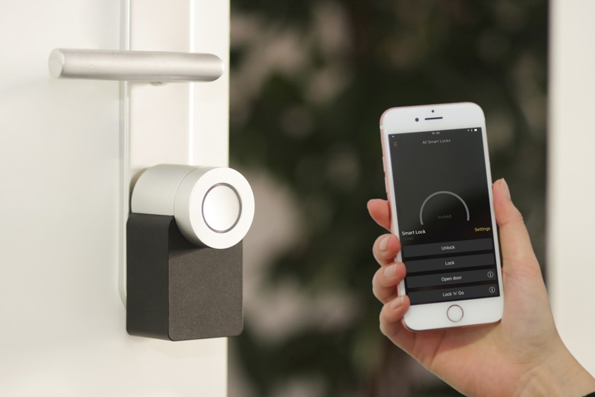 Smart home digital thermostat interface mounted on clean interior wall